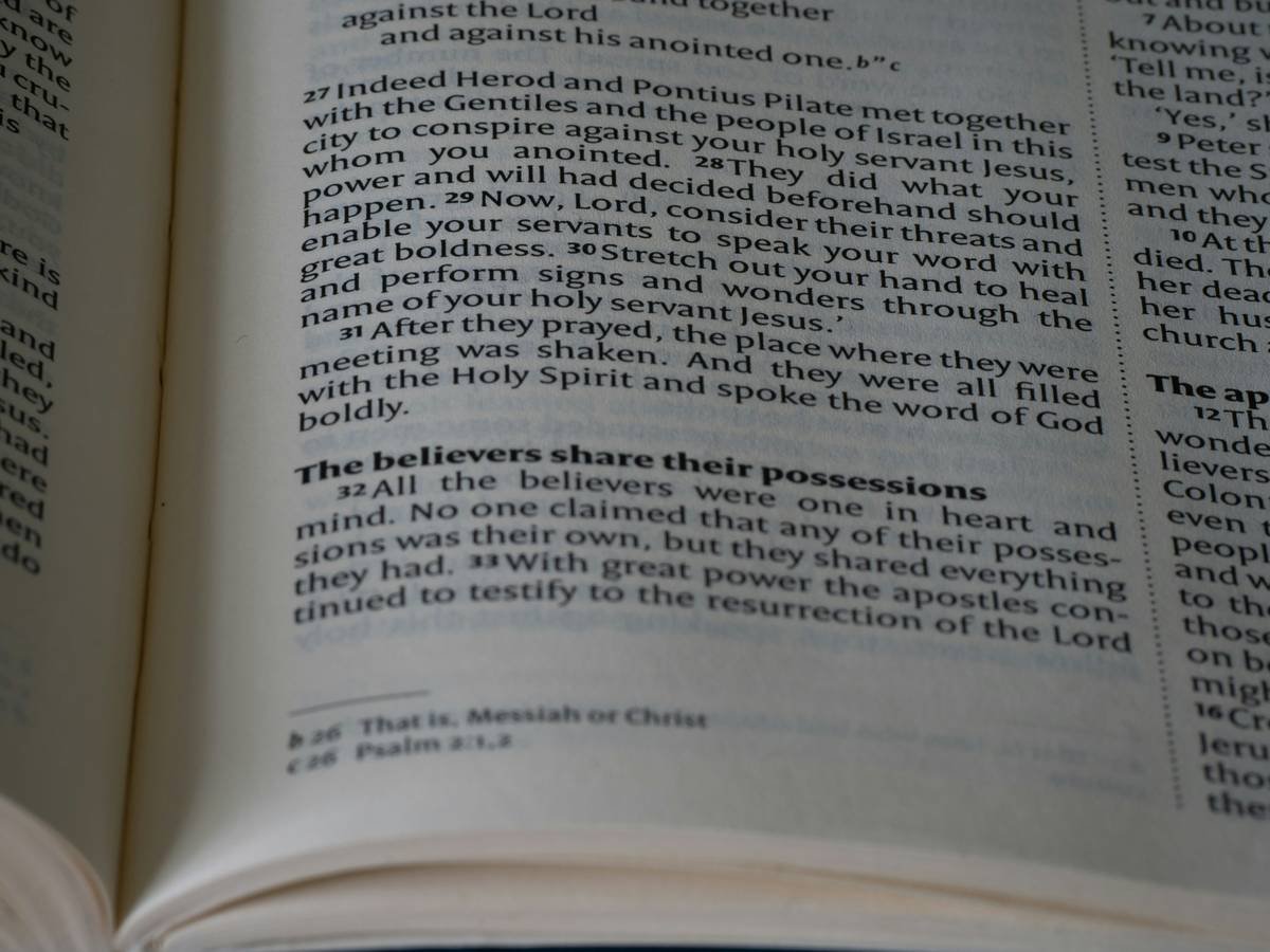 A frustrated man sitting at his desk surrounded by paperwork