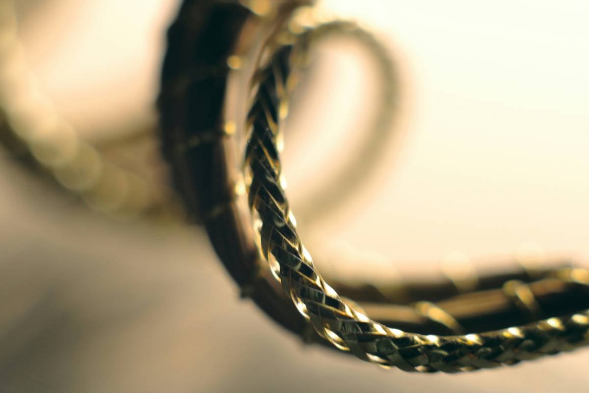 A close-up image showing a credit card next to jewelry pieces and paperwork related to warranties.