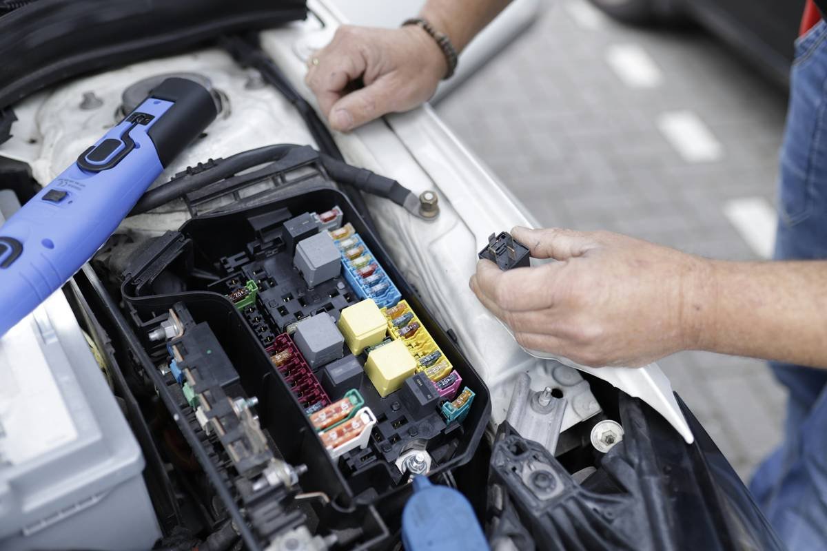 A person repairing a kitchen blender, symbolizing extended repair coverage importance.